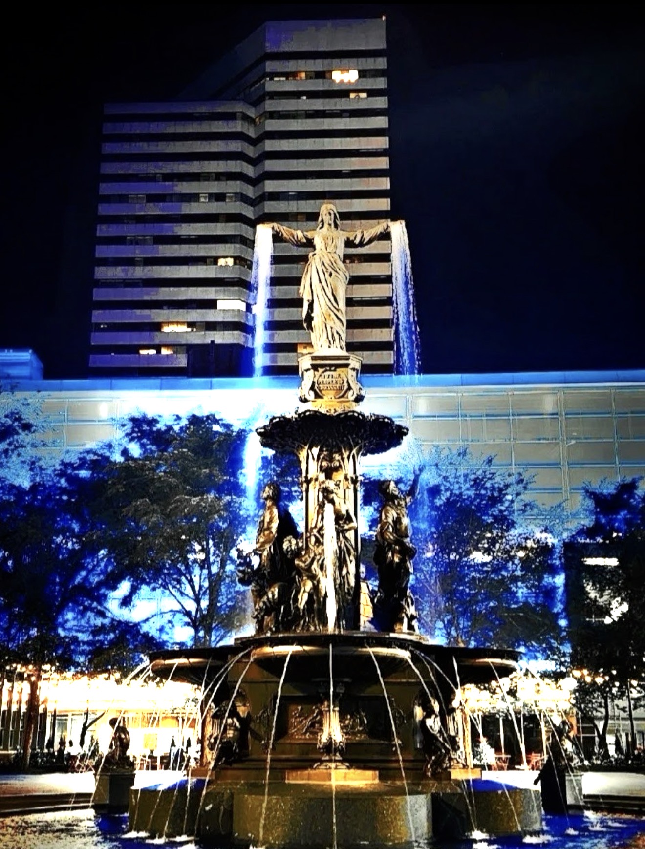 Blue-lit fountain at night