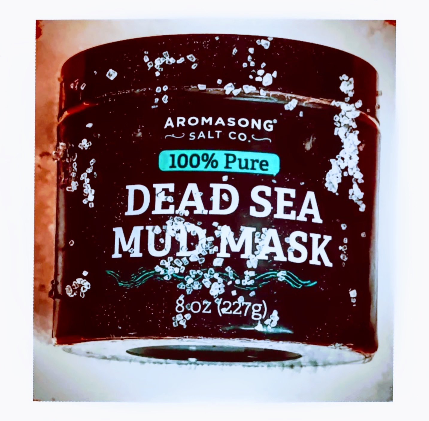 Aromasong Dead Sea mud mask jar dusted with coarse salt crystals