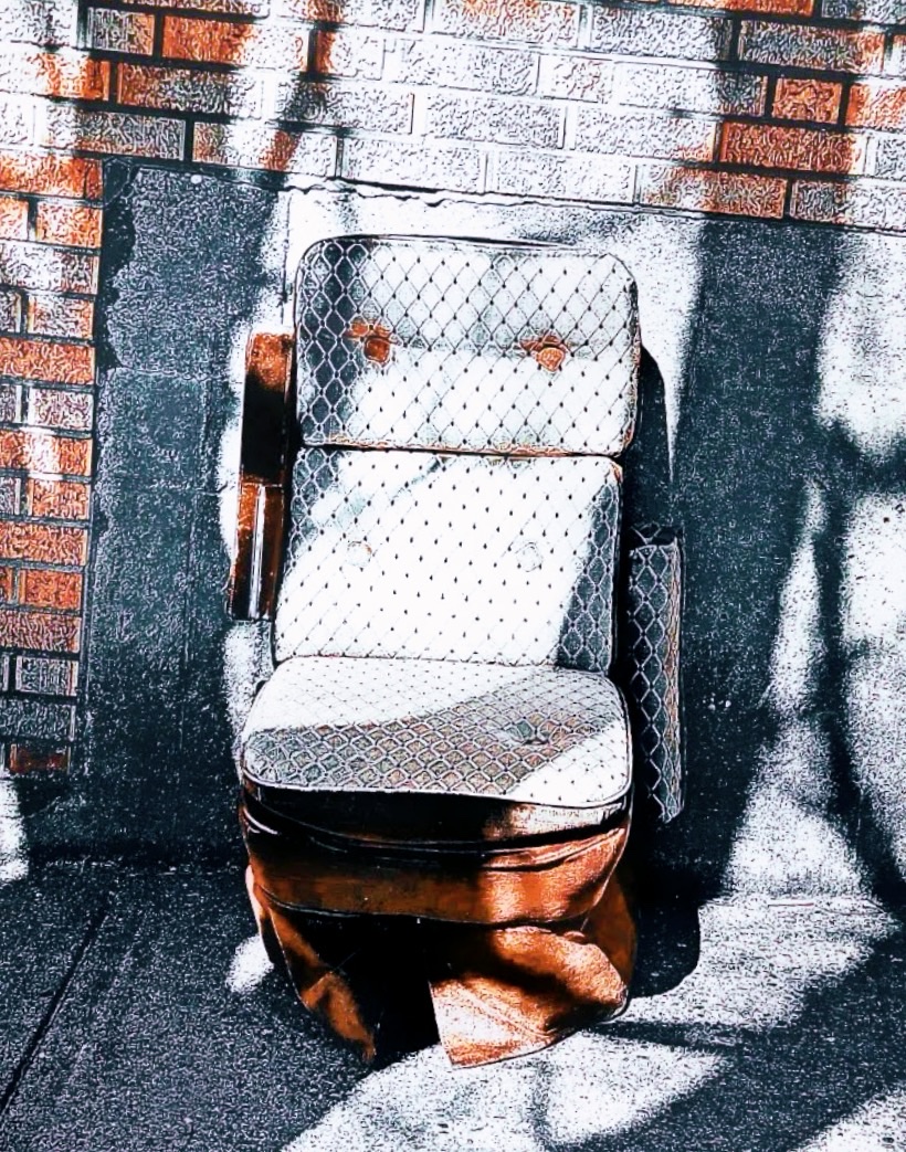 Abandoned chair on a sidewalk