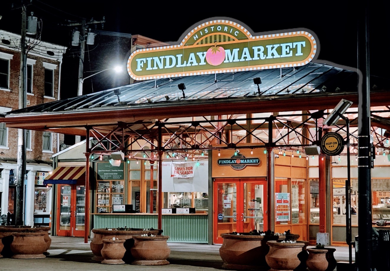 Historic Findlay Market sign lit up at night above the market pavilion