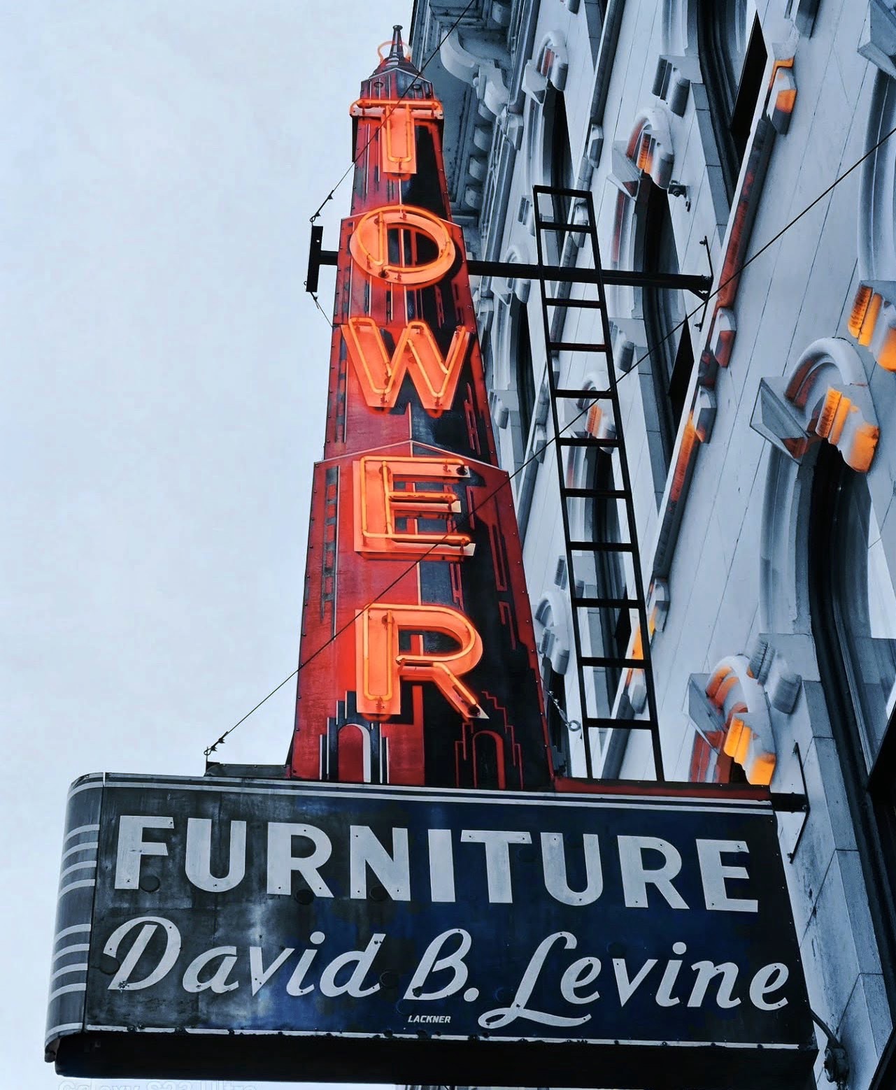Vintage neon Tower Furniture sign on a grey winter sky