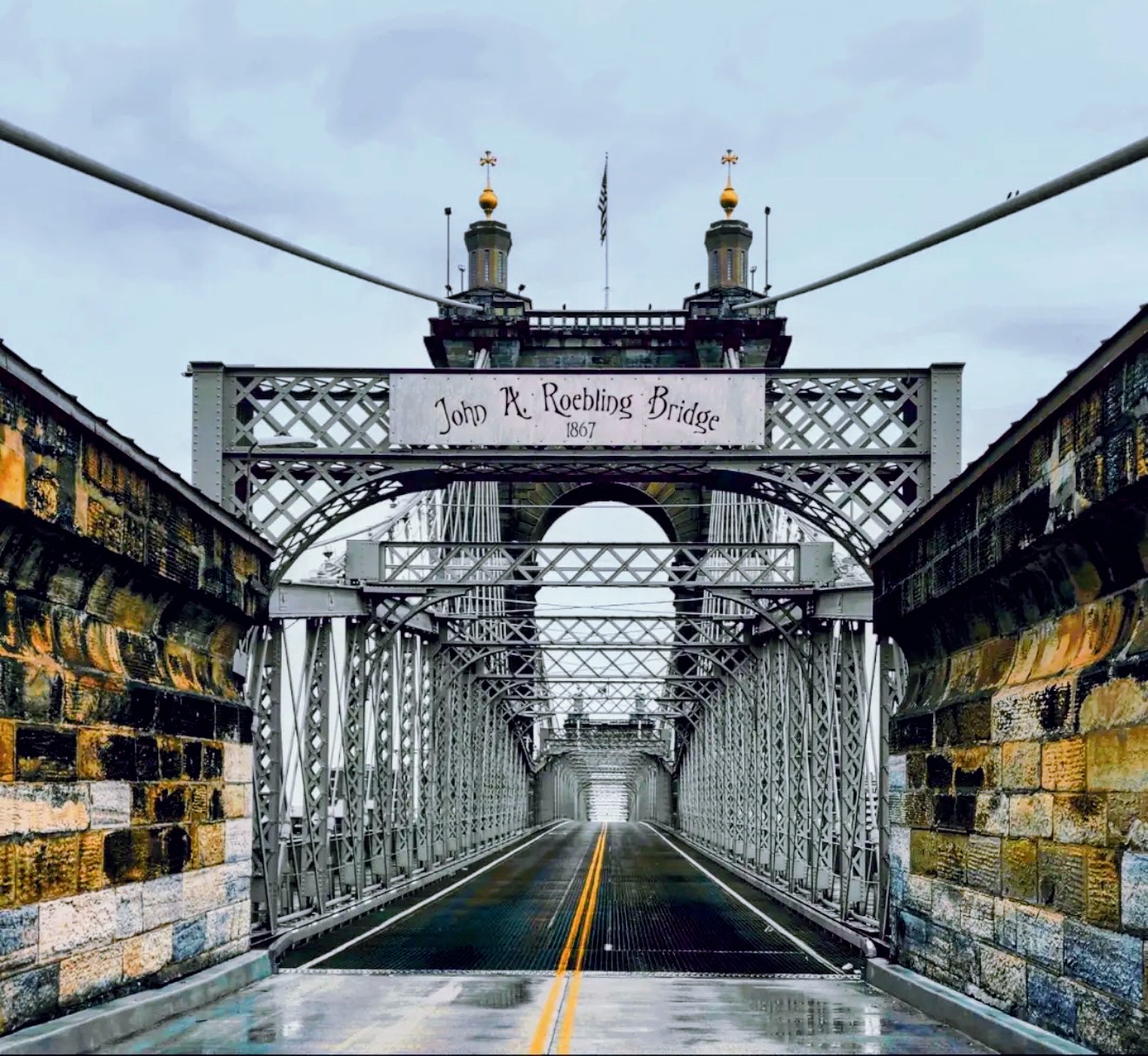 John A. Roebling Bridge 1867 sign above the wet bridge deck